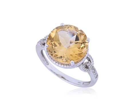 A CITRINE AND DIAMOND RING
Featuring a round cut citrine weighing approximately 5.00 Cts, mounted in a white gold setting mar