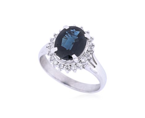 A SAPPHIRE AND DIAMOND CLUSTER RING
Featuring an oval sapphire weighing approximately 3.00 Cts, mounted in a platinum setting