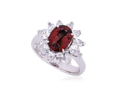 A RUBY AND DIAMOND CLUSTER RING
Featuring an oval cut ruby weighing approximately 2.274 Cts (marked), mounted in a platinum s