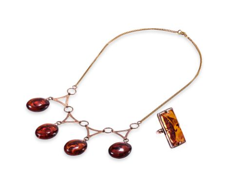 A RUSSIAN GOLD AND AMBER NECKLACE AND RING
The ring with a rectangular domed amber within an openwork frame, both with Soviet