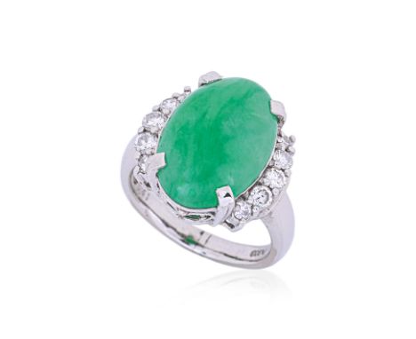 A JADE AND DIAMOND RING
Featuring a cabochon jade mounted in a platinum setting marked 'PT900' to the shank, accented with ro