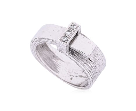 A DIAMOND BUCKLE RING
Featuring a white gold buckle ring marked '585' to the shank, accented with round brilliant cut diamond