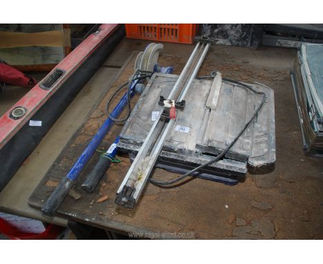 A pipe bender, electric tile cutter and straight edge, tile cutter working at time of testing.