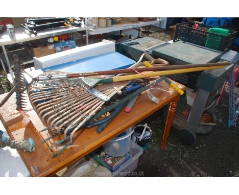 A quantity of gardening tools including rakes, spades, forks, cultivator, pruners, etc.