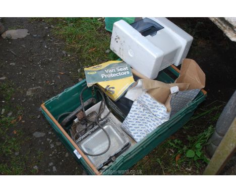 A box containing commercial seat covers, fuse box, exterior light, etc.