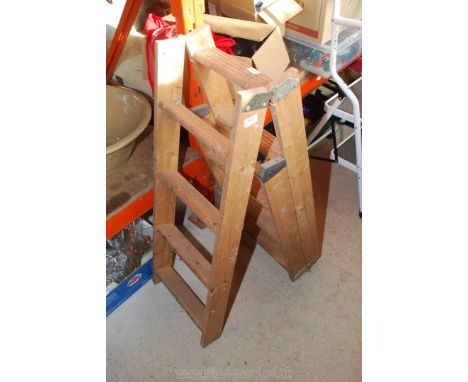 A wooden folding loft ladder, eleven rungs