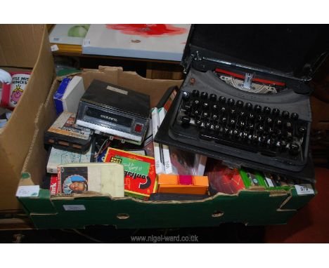 An old typewriter, box of DVD's and an 8 track player with cassettes.