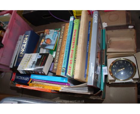A boxed Big Ben alarm clock and a quantity of books.