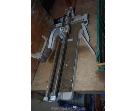 A hand slide action tile cutter.