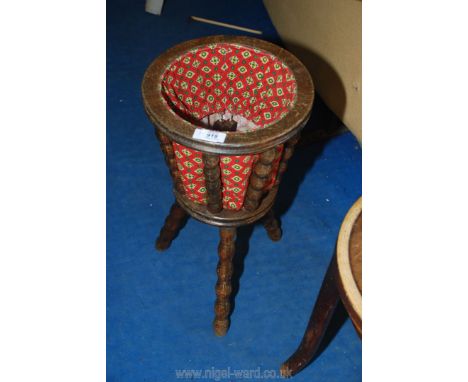 A tripod sewing basket and stand.