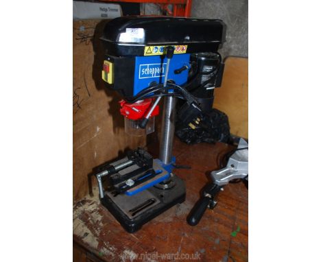 A small Scheppach pillar Drill with clamp vice, working at ti.me of testing