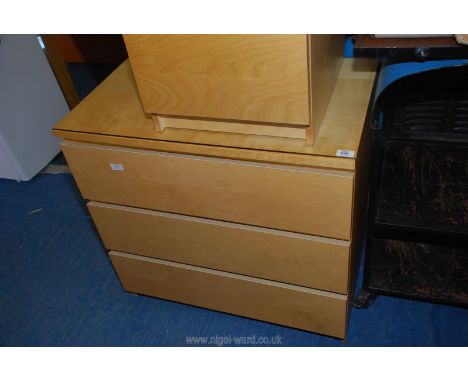 A light cherry wood finished three drawer chest, with protective glass top, 80 cm x 48 cm x 77 cm high.