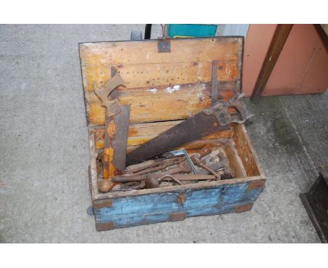 A wooden box of assorted spanners and carpenters tools.