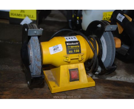 An Einhell bench grinder, no guards but working at time of testing.