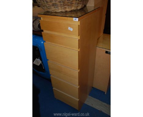 A light cherry wood finished tallboy chest of six drawers with protective glass top, 40 cm wide x 48 cm deep x 124 cm high.