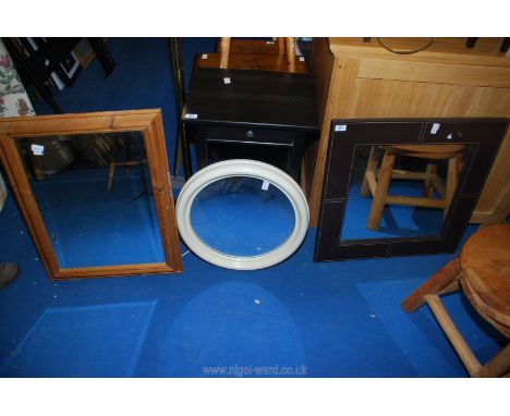 A pine framed mirror, brown leather effect framed mirror and another round mirror.