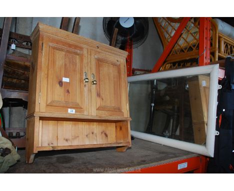 A pine wall cupboard and a large old wall mirror 43" wide x 2' high.
