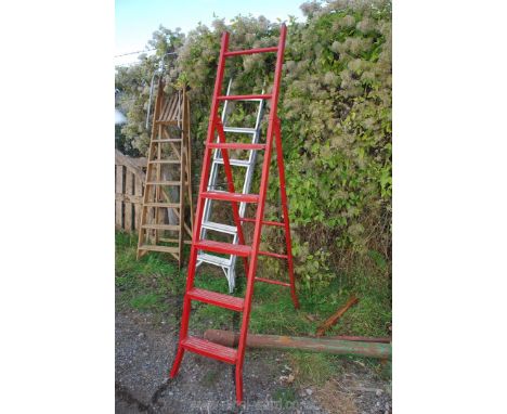 A red five rung metal step ladder.