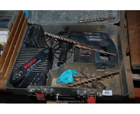 A cordless Bosch hammer with components and charger.