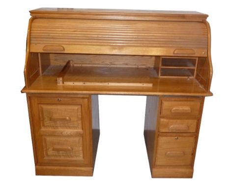 A MODERN LIGHT OAK ROLL-TOP DESK WITH TWO PEDESTALS CONTAINING DRAWERS AND CUPBOARDS 
