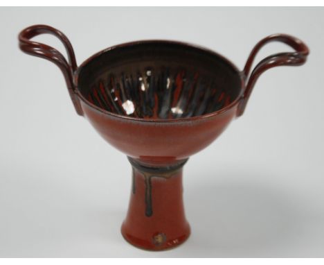 POSSIBLY RANDY JOHNSTON, STUDIO POTTERY TWO HANDLED SMALL PEDESTAL BOWL, of steep sided form with high loop handles and tall 