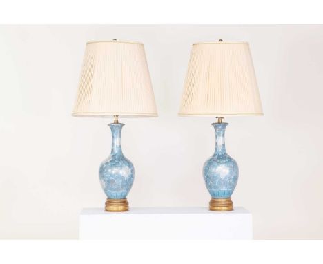 A pair of painted porcelain bottle vase lamps, 20th century, in the Japanese style, each decorated with blue chrysanthemums, 