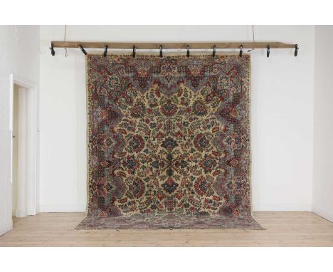 A Persian wool carpet,mid-late 20th century, Kirman, woven with polychrome flowers and foliage to a cream ground,315 x 243cmC