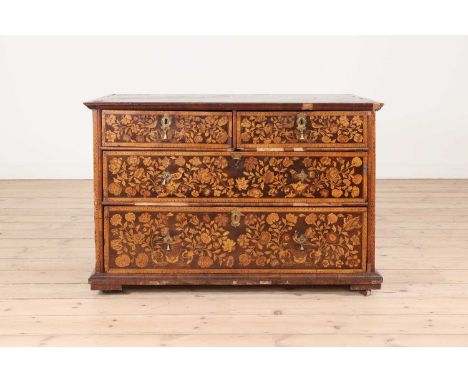 A William and Mary walnut and marquetry chest of drawers,the finely inlaid top with a central oval panel depicting a floral a