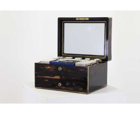 A Victorian coromandel dressing box,London, 1869, the case with brass corners, the interior with a mirror to the lid, ten sil