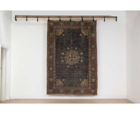 An Agra rug of Persian Ardabil design,late 19th century, Indian, with a large central medallion surrounded by lamps and folia