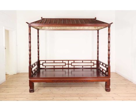 A hardwood daybed in the Chinese Qing dynasty style,late 20th century, with a pagoda top and geometric decoration, raised on 