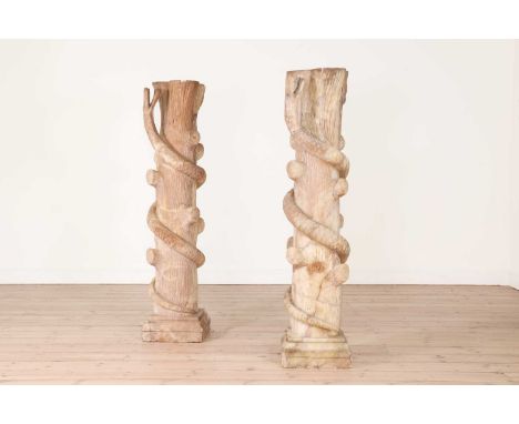 A pair of alabaster jardinière stands, 20th century, each in the form of a tree trunk encircled by a serpent,31cm wide31cm de