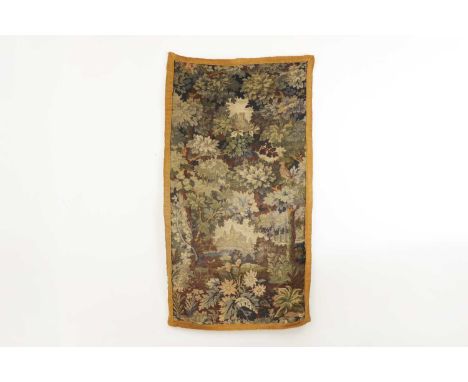 A verdure tapestry fragment,17th century, probably Flemish, depicting verdant foliage within a banded border,162 x 90cmCondit