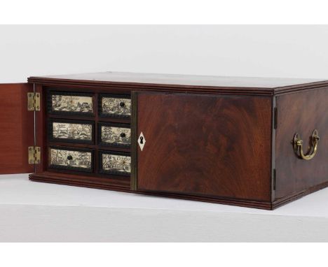 A flame mahogany and ivory table cabinet,19th century, incorporating earlier elements, the plain top with a reeded edge, flan