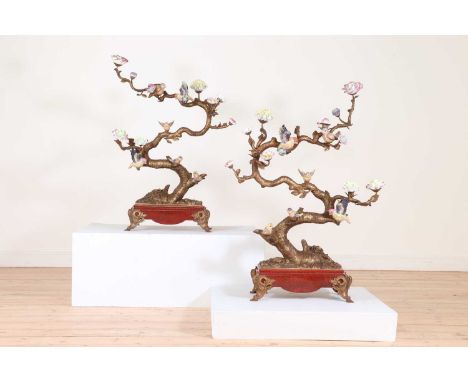 A pair of large gilt-metal and porcelain candelabra in the Chinese style, late 20th century, each in the form of a blossoming