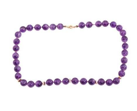 An amethyst and diamond bead necklace; the circular amethyst beads interspaced with five diamond set roundels; the whole to a