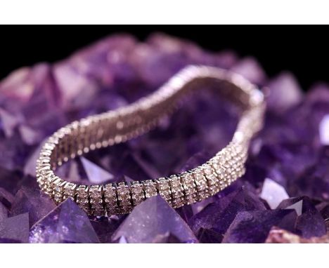 A three-row diamond tennis bracelet, featuring arrays of brilliant diamond with an estimated total weight of 6.48ct, claw set