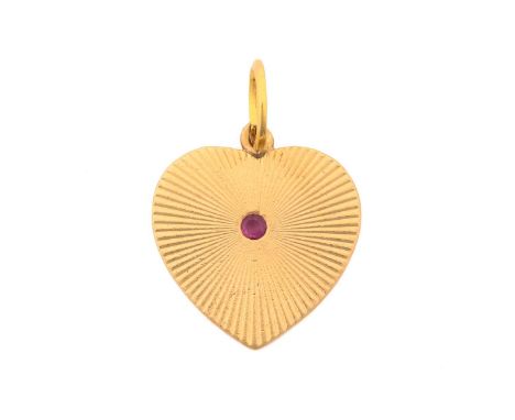 A heart-shaped pendant, set with ruby in the centre, on an engraved starburst background, attached to a loop bail, marked '14
