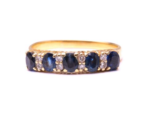 A sapphire and diamond half hoop ring, comprises five oval-cut sapphires, flanked by diamond accents, to a tapering shank, ye