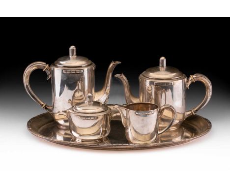 An Art Deco Danish white metal five piece tea service by Christian F Heise comprising an oval tray, a milk jug, a two handled