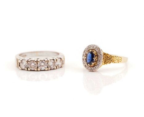 Two gem-set 18ct gold rings; The first consists of an oval-shaped faceted synthetic sapphire within a surround pavéd with whi