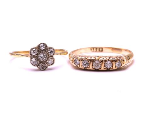 Two diamond set rings, the first ring features five old cut diamonds in a half hoop engraved setting on a yellow metal stampe