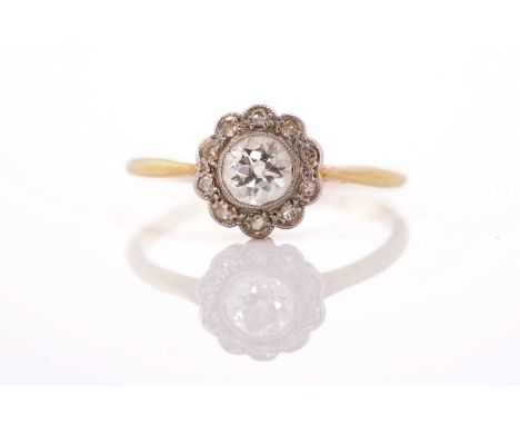 A diamond daisy head cluster ring, comprising eleven old-cut diamonds in a platinum flowerhead setting with millgrain details