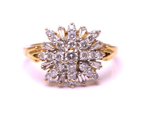 A diamond cluster ring, comprises round brilliant-cut and tapered baguette-cut diamonds forming a starburst design, with trum