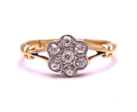 An old cut diamond daisy cluster ring, featuring 7 old cut diamonds with an estimated weight of 0.25ct, in a daisy head setti