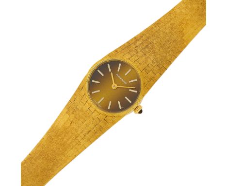 18 kt., mechanical, round brushed cross hatch brownish gold-tone dial, applied luminous baton markers, round tiger's eye crow