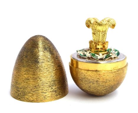 A silver and silver gilt egg of typical form, by Stuart Devlin, opening to reveal enamelled flowers and the three feathers of