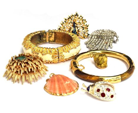 A lot of costume jewellery in a wooden box to include a bracelet marked KJL (Kenneth Lane), Christian Dior brooch, bracelet s