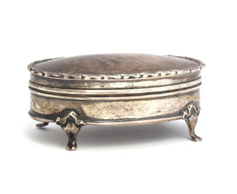 A oval silver trinket box, marks rubbed, hinged lid, on four feet, 9.5cm wide 