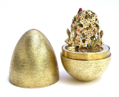 A silver and silver gilt egg of typical form, by Stuart Devlin, opening to reveal enamelled flowers and rabbits, cased